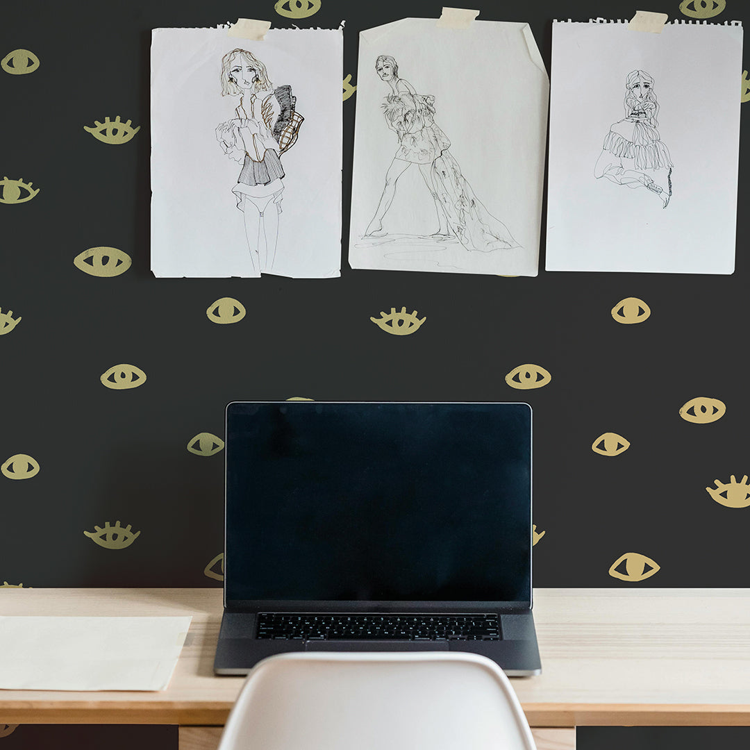 Eye Removable wallpaper by Bobby Berk in a dorm room behind a computer desk. #color_black-and-gold-eyes