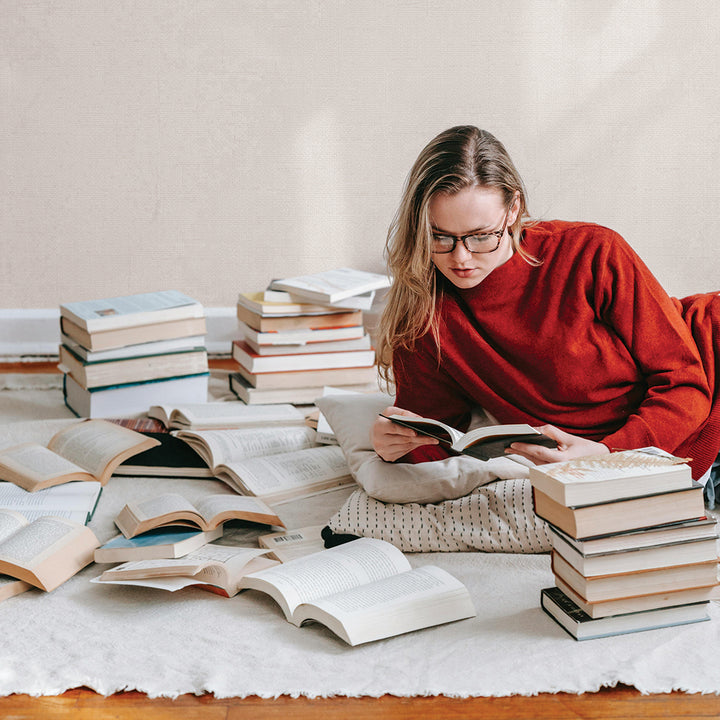 Burlap Removable Wallpaper - A college student reading a book in a room featuring light linen color Burlap Peel And Stick Wallpaper in ocean mist faux burlap | Tempaper #color_linen-burlap