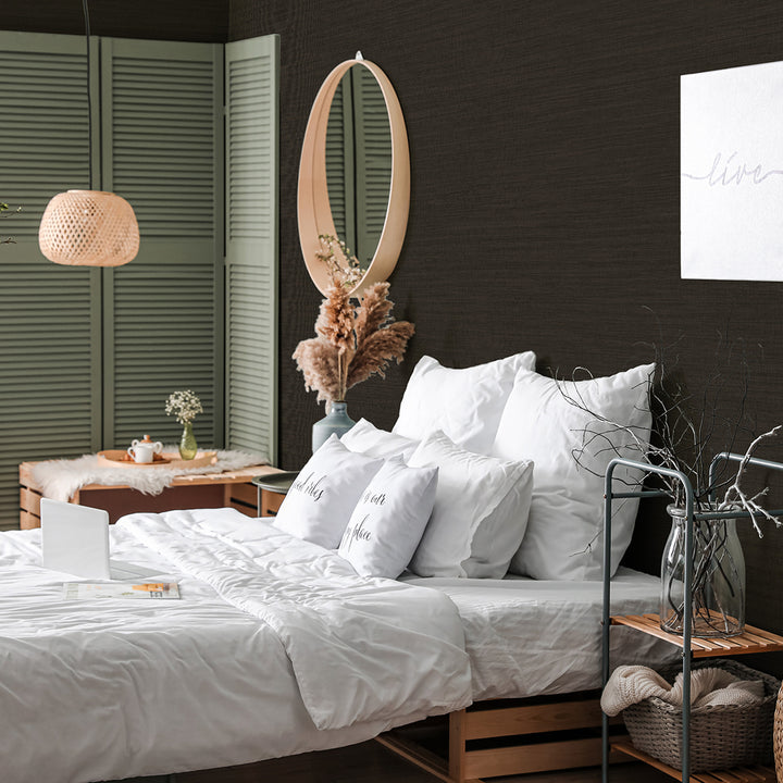 Faux Horizontal Grasscloth Removable Wallpaper - A bedroom with a bed and wood furniture featuring Faux Horizontal Grasscloth Peel And Stick Wallpaper in textured black raven | Tempaper#color_textured-black-raven