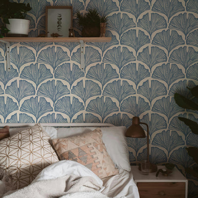 Feather Palm Removable Wallpaper by Novogratz - A bed and bedside table with a shelf above in a apartment bedroom featuring Tempaper's Feather Palm Peel And Stick Wallpaper by Novogratz in waverly blue palm on the wall behind the bed. | Tempaper #color_waverly-blue-palm