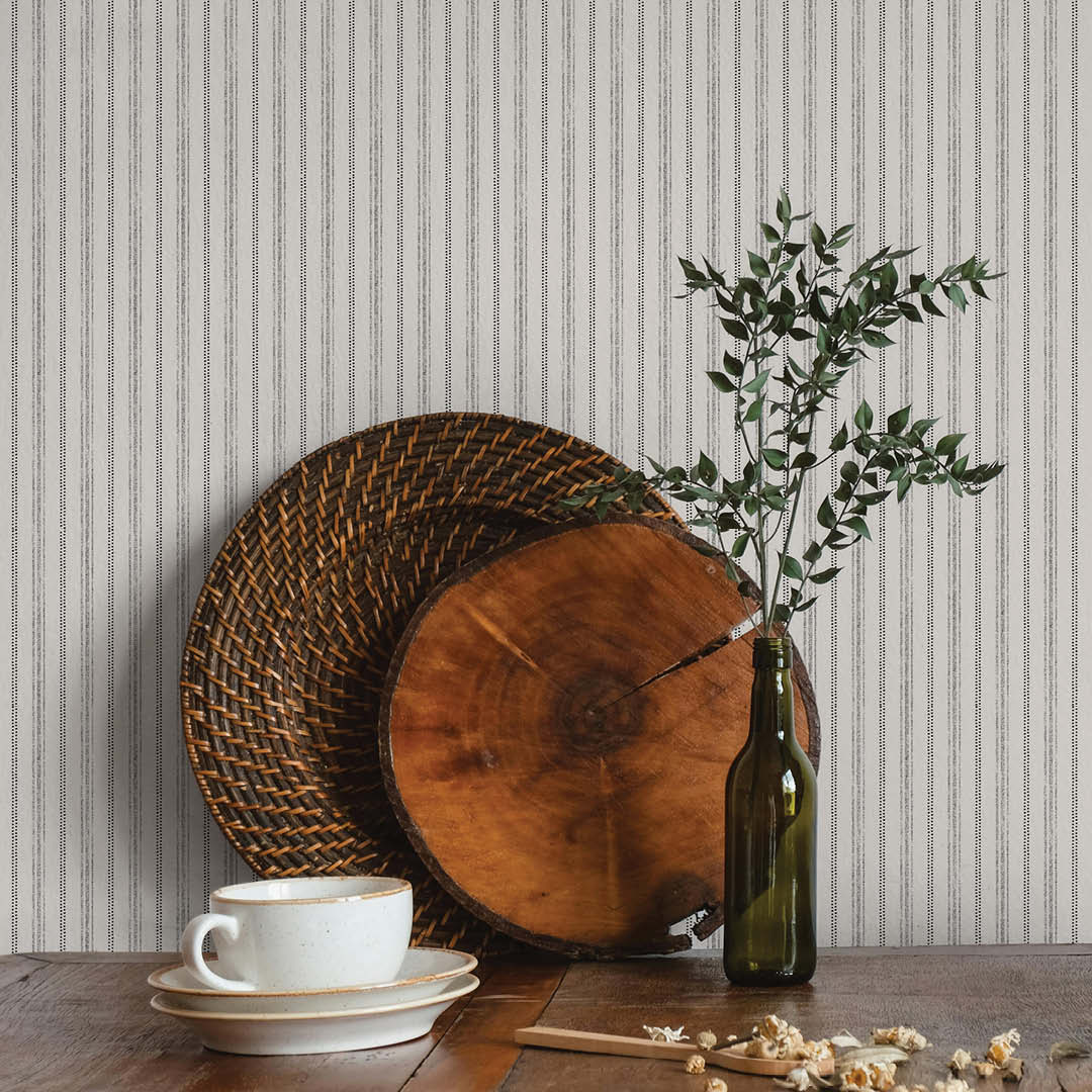 Nautical Stripe Removable Wallpaper - A kitchen table with placemats and heritage style decor against a backdrop of Tempaper's Nautical Stripe Peel And Stick Wallpaper | Tempaper#color_charcoal-and-cotton