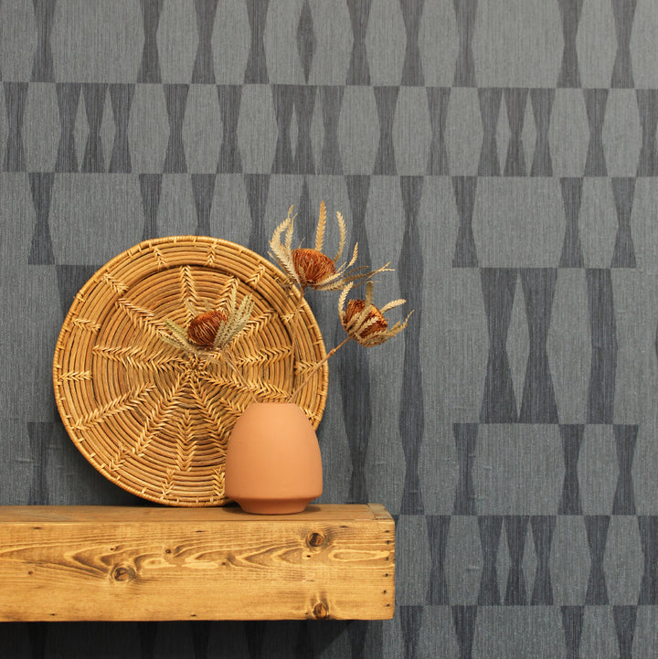 Faux Grasscloth Geo Removable Wallpaper - A wood shelf on a wall featuring Faux Grasscloth Geo Peel And Stick Wallpaper in textured carbon | Tempaper#color_textured-seagrass