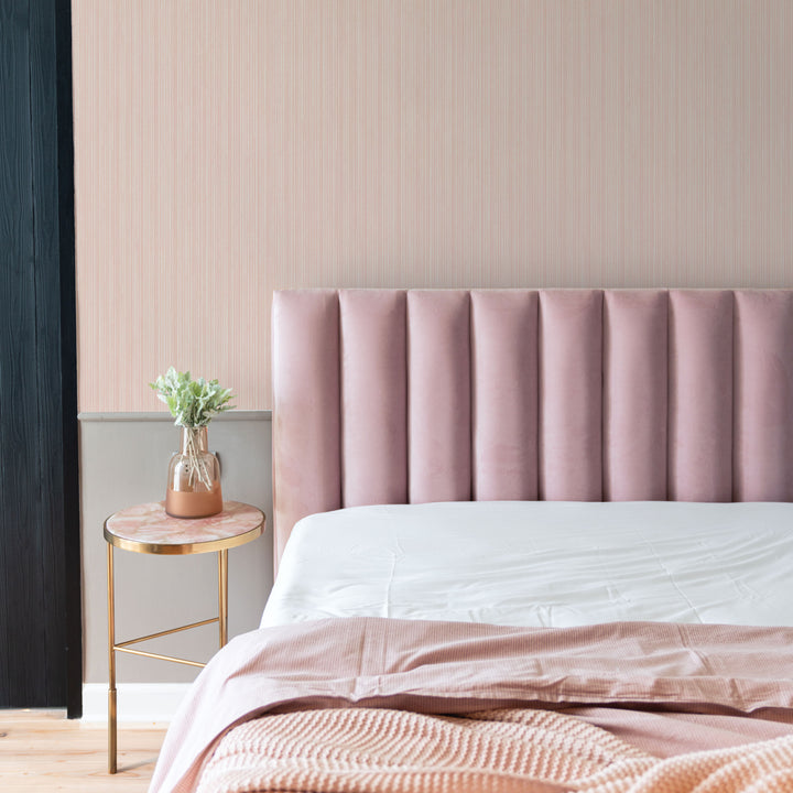 Faux Grasscloth Removable Wallpaper - A bedroom with a pink bed and gold nightstand featuring Faux Grasscloth Peel And Stick Wallpaper in textured blush | Tempaper#color_textured-blush