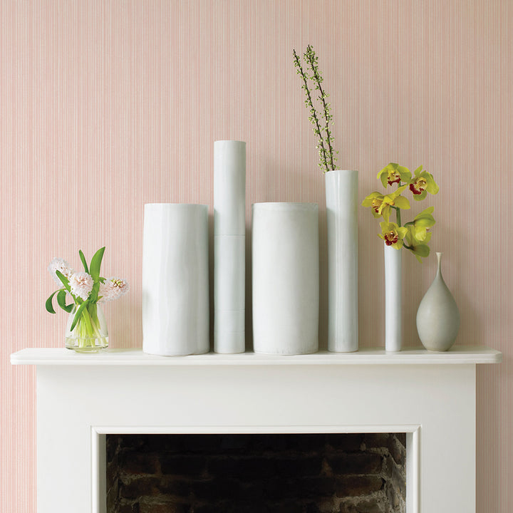 Faux Grasscloth Removable Wallpaper - A white fireplace with plants and white vases in a room featuring Faux Grasscloth Peel And Stick Wallpaper in textured blush | Tempaper#color_textured-blush