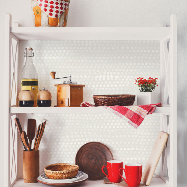 Moire Dots Removable Wallpaper - A bookcase with kitchen utensils featuring Tempaper's Moire Dots Peel And Stick Wallpaper in pearl grey dots | Tempaper#color_pearl-grey-dots