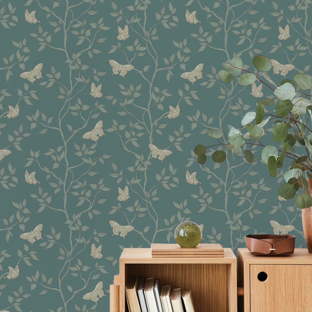 Monarch Non-Pasted Wallpaper - A wood dresser with a plant in a room featuring Monarch Unpasted Wallpaper in spruce | Tempaper#color_spruce