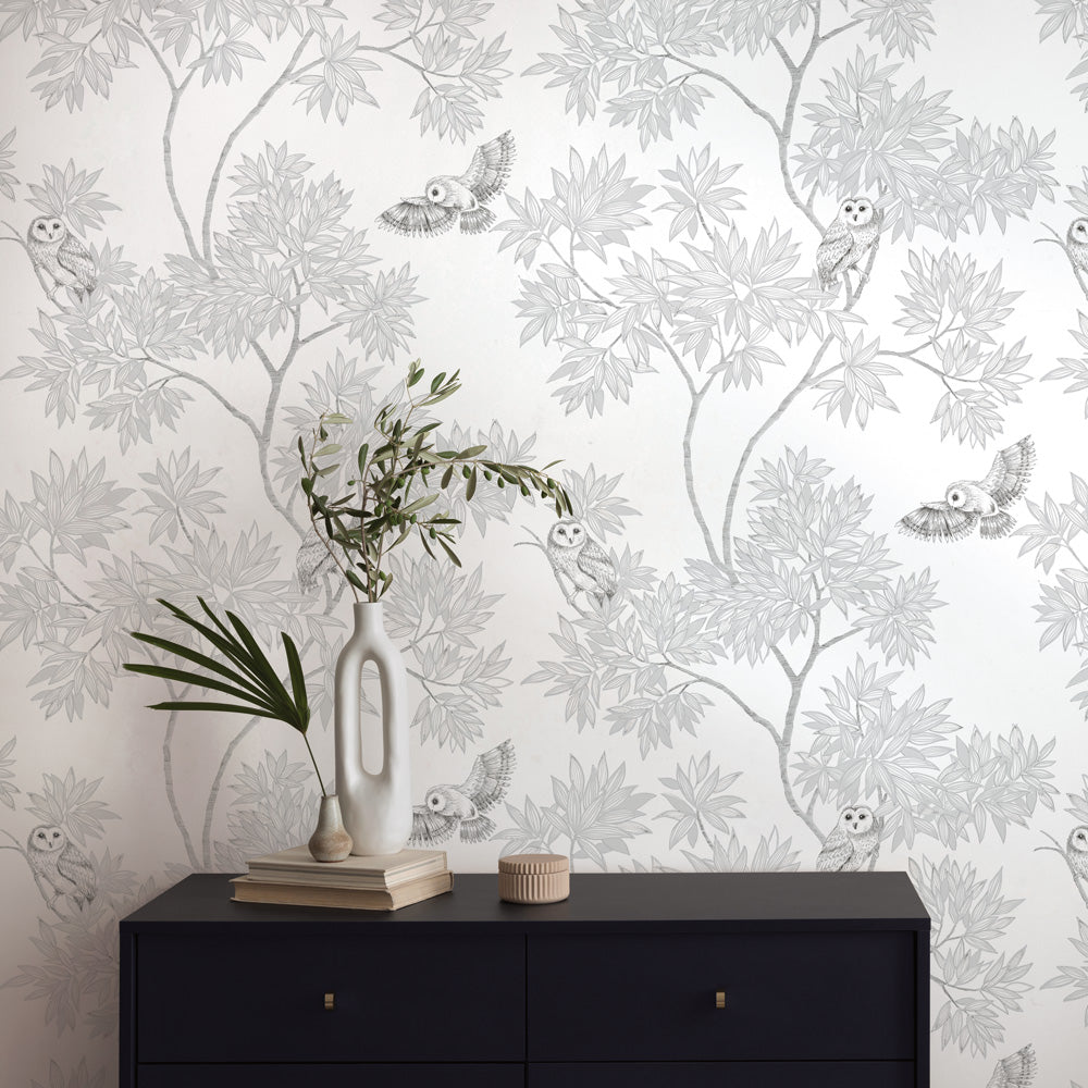 Parliament Non-Pasted Wallpaper - A black dresser and plants with Parliament Unpasted Wallpaper in snow white | Tempaper#color_snow-white