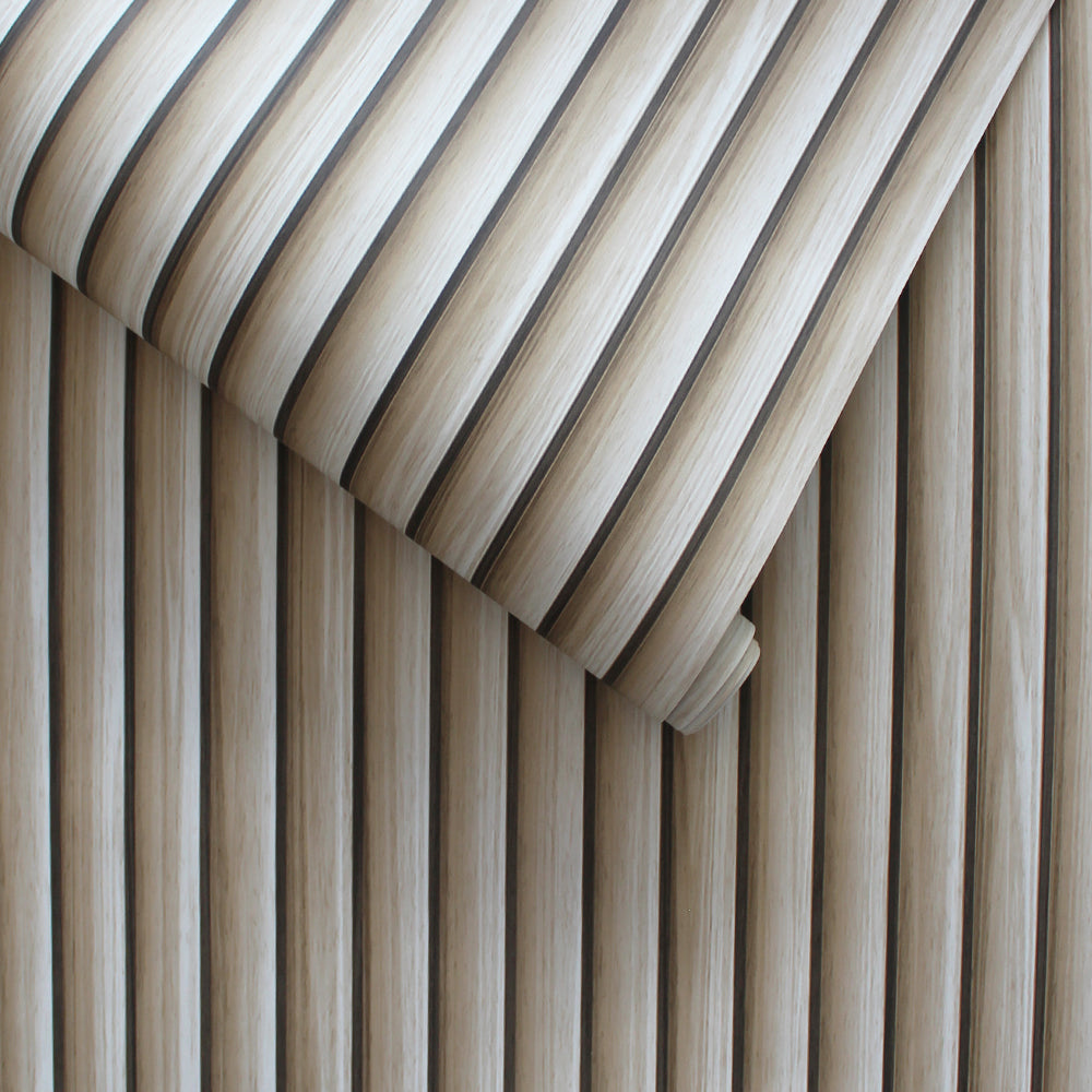 A slightly unraveled roll of Reeded Wood peel and stick wallpaper.