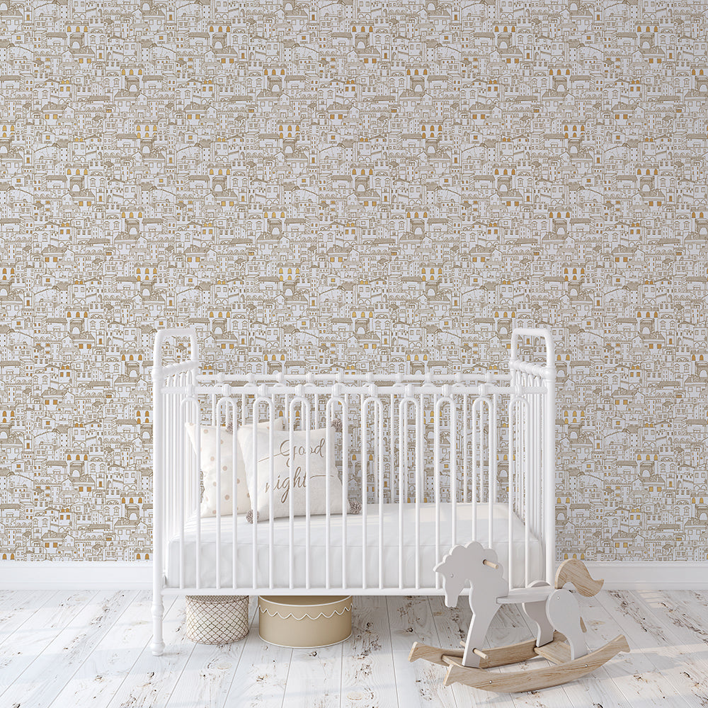 Amalfi WALLPAPER in metallic gold in a nursery behind a white crib.