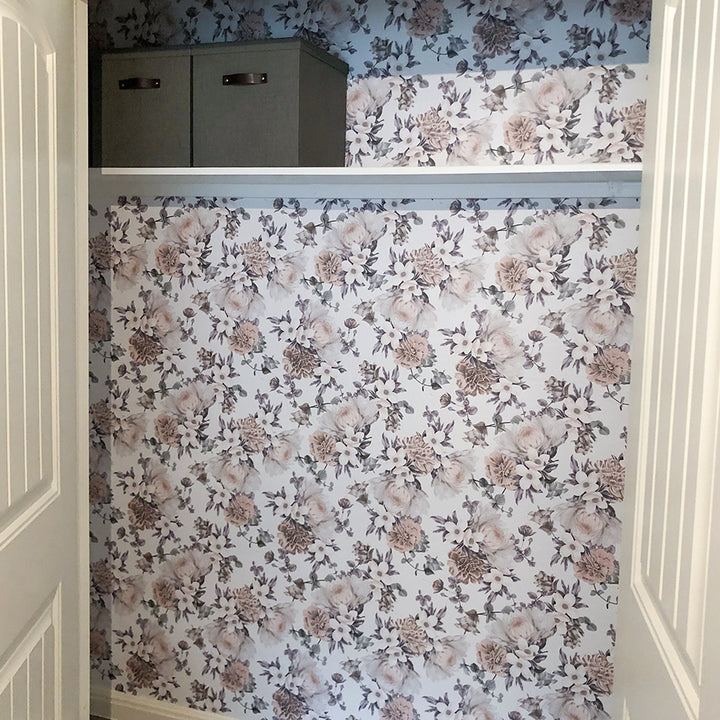 Botanical WALLPAPER in mauve pink displayed in a closet.