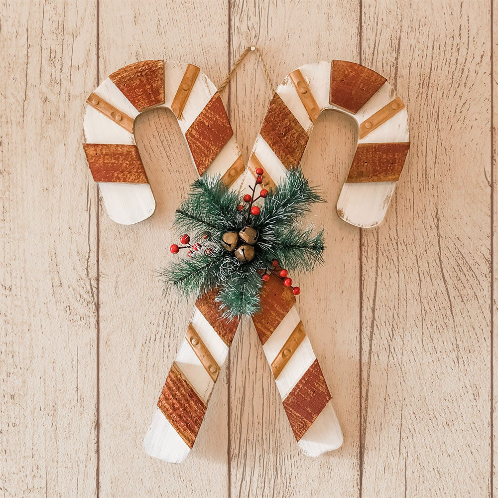 Tempaper's Farmhouse Planks Peel And Stick Wallpaper shown behind two candy canes.