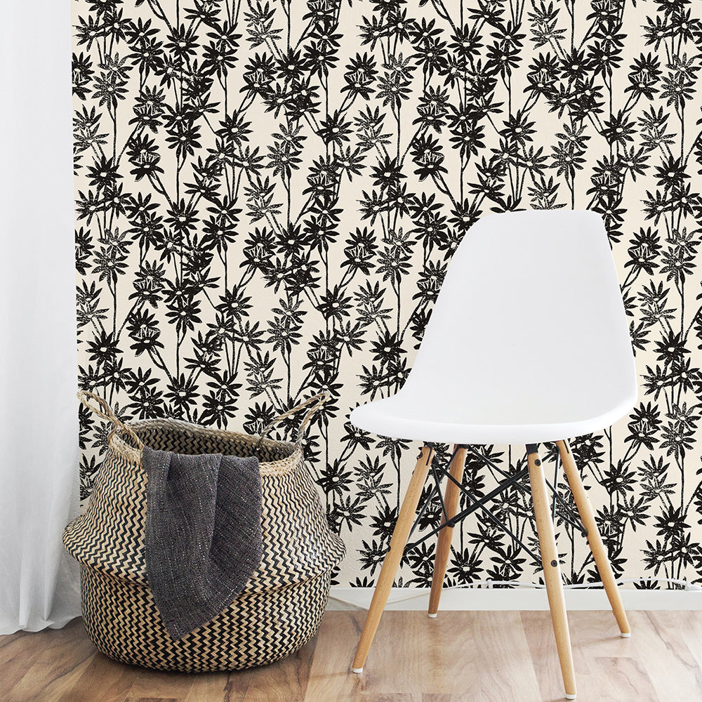 Tempaper's Daisy Bloom Peel And Stick Wallpaper By Novogratz shown behind a basket and chair.