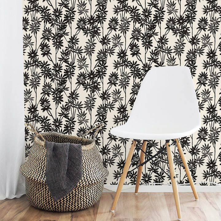 Tempaper's Daisy Bloom Peel And Stick Wallpaper By Novogratz shown behind a basket and chair.