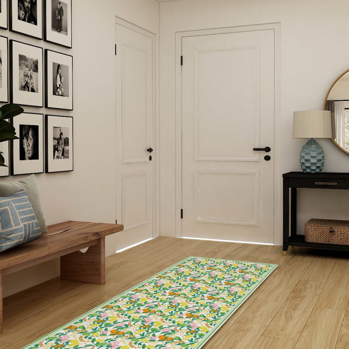 Tempaper's Citrus Vinyl Rug shown in front of a door.#color_green-citrus