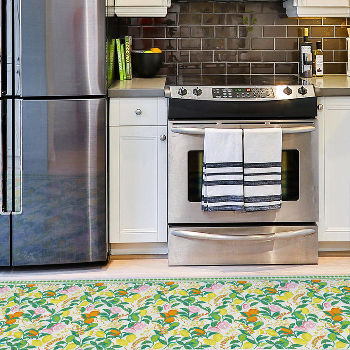 Tempaper's Citrus Vinyl Rug shown in a kitchen.#color_green-citrus