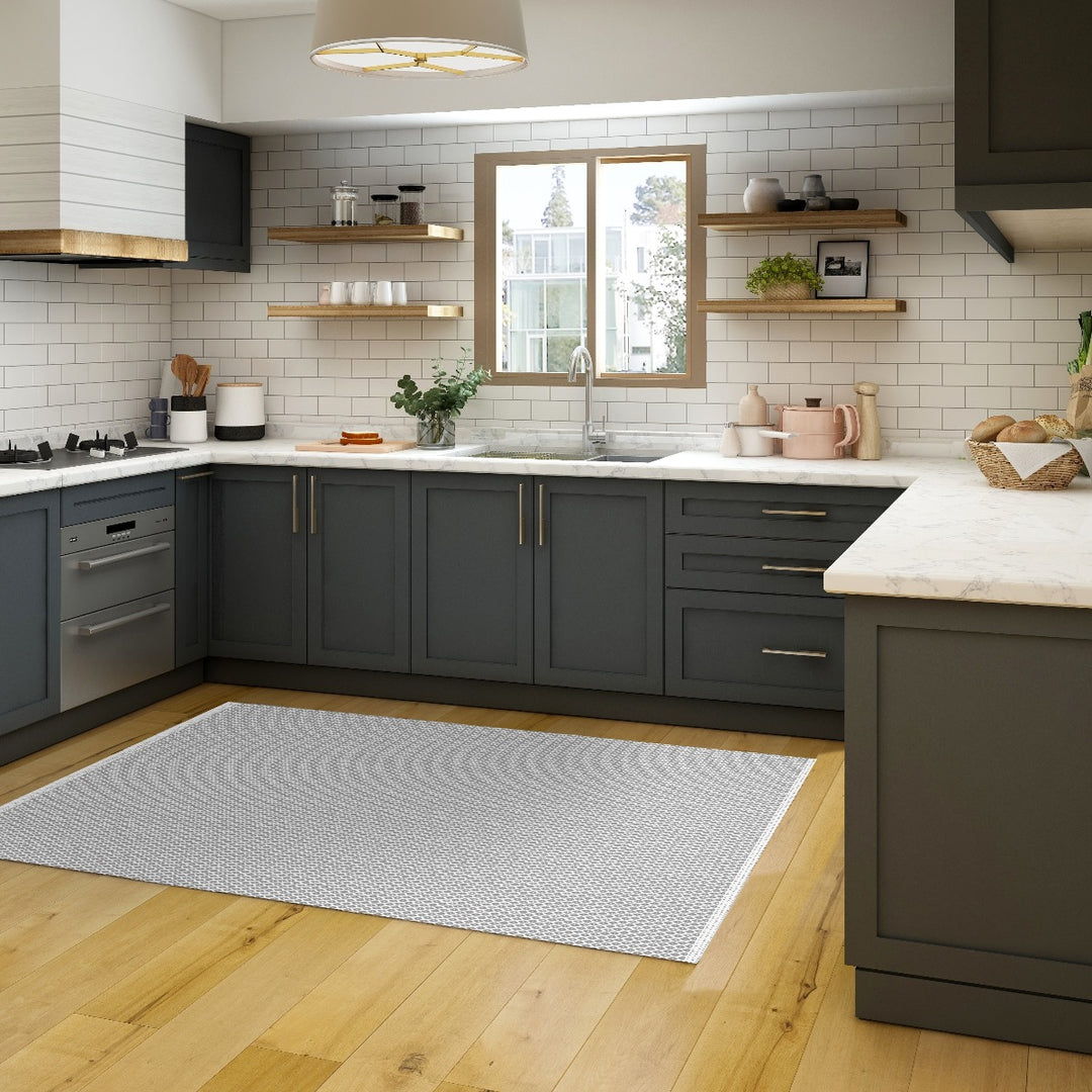 Tempaper's Diamond Geometric Vinyl Rug shown in a kitchen in front of a sink.