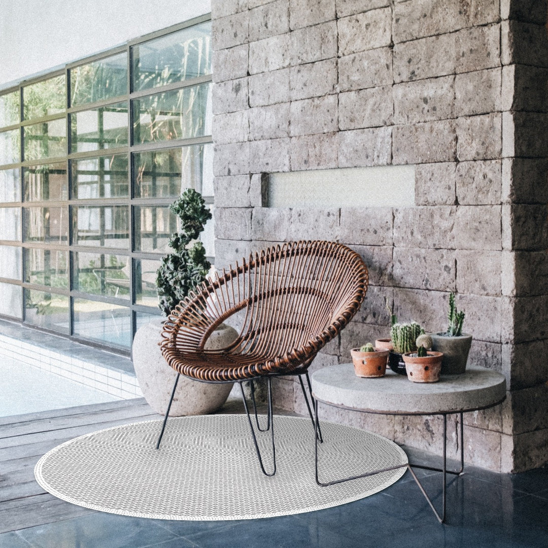 Tempaper's Diamond Geometric Vinyl Rug shown under a chair.