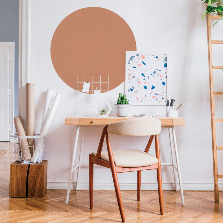 Tempaper's Circle Wall Decal shown behind a desk.