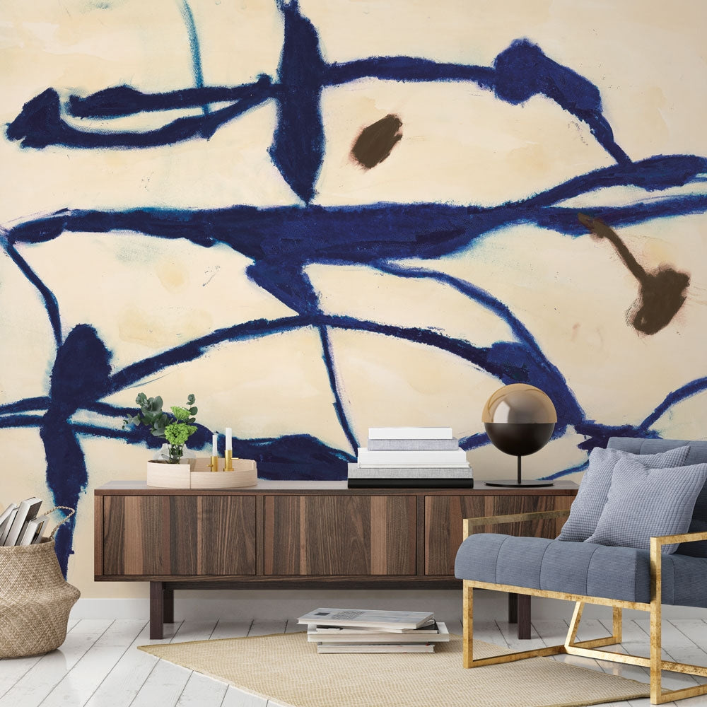 Tempaper's Figures Peel And Stick Wall Mural By Zoe Bios shown behind a couch and a sideboard.